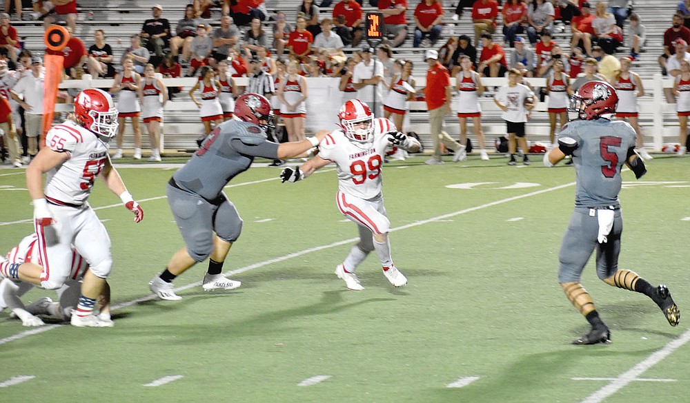 MARK HUMPHREY ENTERPRISE-LEADER/Farmington's defensive linemen David Stettmeier (left) and Braden Bullington persistently put pressure on Springdale quarterback Landon Phipps during the Cardinals' 20-19 victory to wrap up the nonconference portion of the football season on Friday at Jarrell Williams Bulldog Stadium.