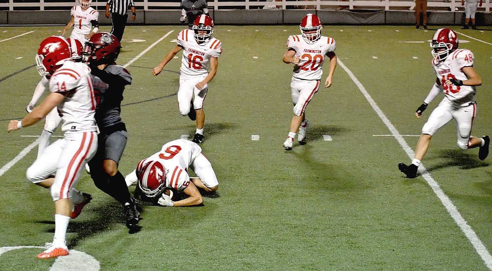 MARK HUMPHREY ENTERPRISE-LEADER/Farmington senior Kyler Petree (No. 6) recovers a fumble at Springdale's 12-yard line which set up a game-tying touchdown drive and winning extra-point kick Friday at Jarrell Williams Bulldog Stadium. Racing in to help cover are (from left) senior Myles Harvey (No. 14), junior Marcus Clevenger (No. 1), junior Drew White (No. 16), sophomore Cole Cantrell (No. 20) and sophomore Asher Hendrix (No. 48).