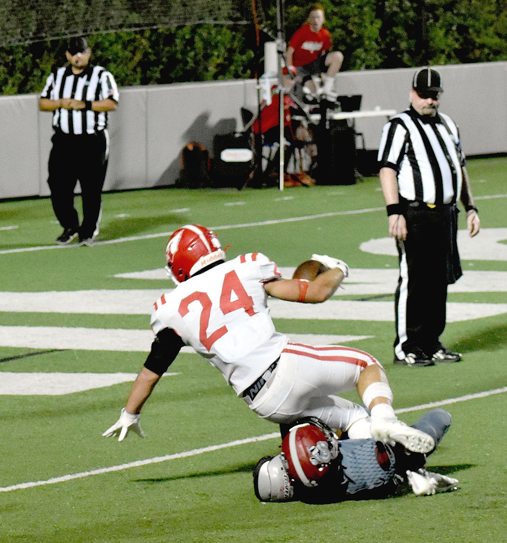 MARK HUMPHREY ENTERPRISE-LEADER/Farmington senior tailback Caden Elsik refuses to go down short of the goal line scoring on a determined power 8-yard rush to tie the game with 7:32 remaining in the fourth quarter. The Cardinals took the lead on Luis Zavala's extra-point kick and won 20-19.