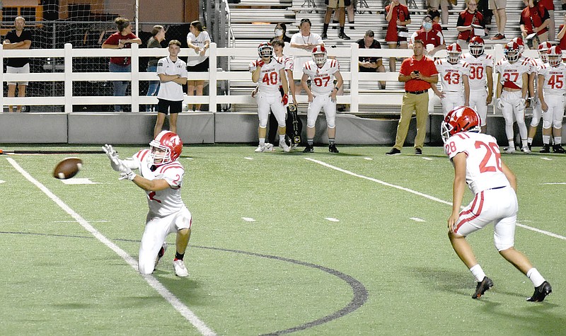 MARK HUMPHREY  ENTERPRISE-LEADER/Farmington Walker McCumber receives the snap as senior Luis Zavala prepares to kick the extra-point kick which won Friday's nonconference football game at Springdale, 20-19. Cardinal senior tailback Caden Elsik scored on an 8-yard carry with 7:32 remaining in the fourth quarter to set up the winning kick.