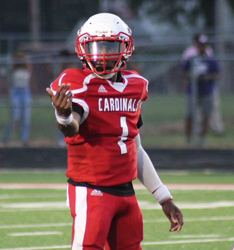 Photo by: Michael Hanich
Camden Fairview Cardinals quarerback adjusts the play before the snap
