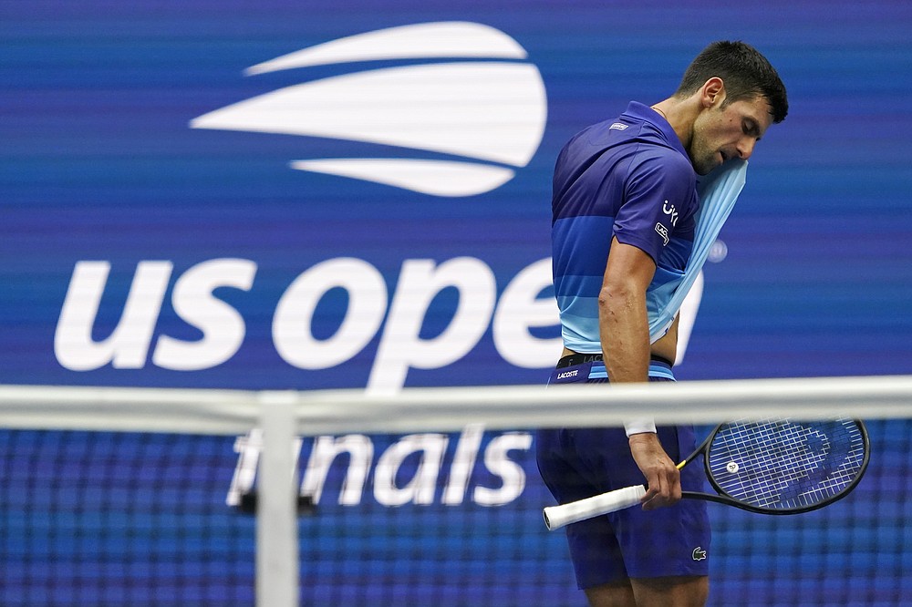 Novak Djokovic, of Serbia, wipes sweat from his face between serves from Daniil Medvedev, of Russia, during the men's singles final of the US Open tennis championships, Sunday, Sept. 12, 2021, in New York. (AP Photo/Elise Amendola)