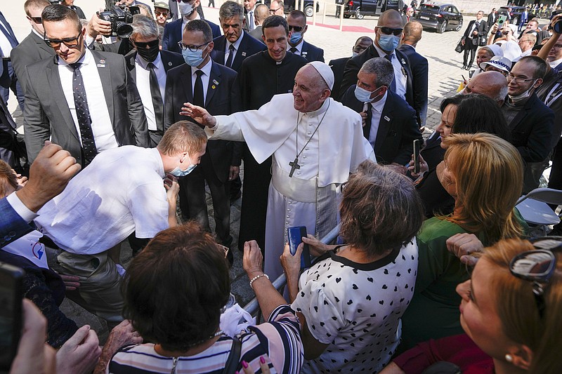 Pope Francis blesses an unidentified man as he greets the crowd while leaving the Cathedral of Saint Martin, in Bratislava, Slovakia, Monday, Sept. 13, 2021. Francis is on a four-day visit to Central Europe, in Hungary and Slovakia, in his first big international outing since undergoing intestinal surgery in July. (AP Photo/Petr David Josek)