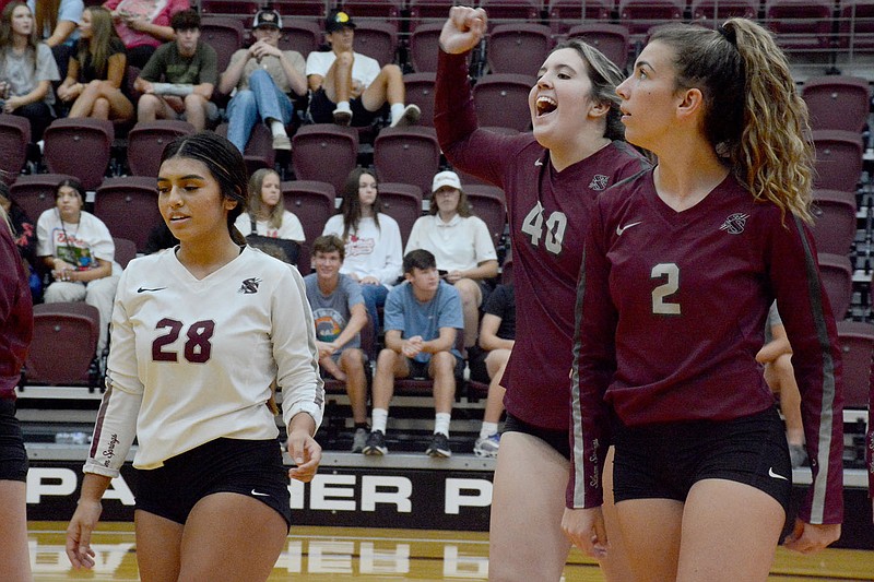 Graham Thomas/Herald-Leader
Siloam Springs senior Gracie Greer (middle) celebrates with teammates Allison Williamson (left) and Anna Wleklinski after the Lady Panthers scored a point Monday against Huntsville.