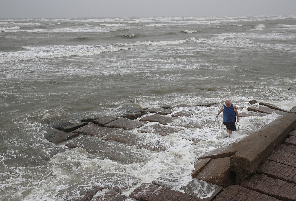 John Pittman, a nurse who works in emergency medicine, fishes to decompress as Tropical Storm Nicholas heads toward the Texas coast, Monday, Sept. 13, 2021, along the seawall in Galveston, Texas. (Jon Shapley/Houston Chronicle via AP)