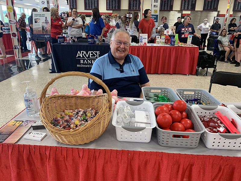ALEXUS UNDERWOOD/SPECIAL TO MCDONALD COUNTY PRESS Photo of Jim Armstrong at his booth representing Daniel Cowin Construction LLC. Armstrong was handing out candy and additional items such as pens, stress, balls, and keychains.