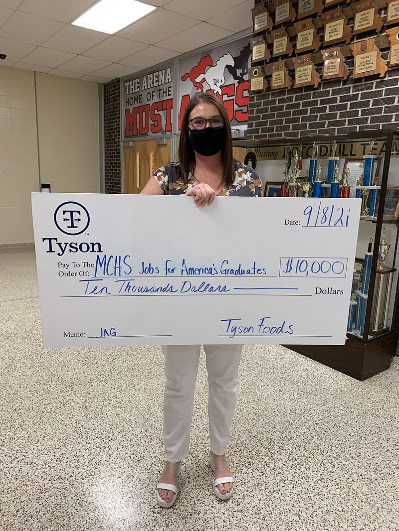 ALEXUS UNDERWOOD/SPECIAL TO MCDONALD COUNTY PRESS Photo of Sara Reynolds, MCHS JAG teacher, and mock check from Tyson Foods. Reynolds said she is looking forward to working with Tyson Foods through the JAG program.