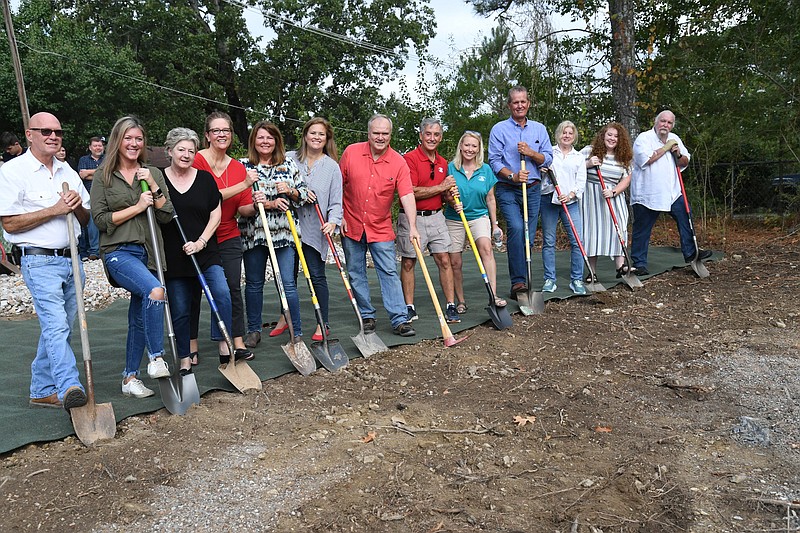 People who will have rooms named after them in The Our Promise House break ground for the building at 230 Franklin St. on Saturday morning. - Photo by Tanner Newton of The Sentinel-Record