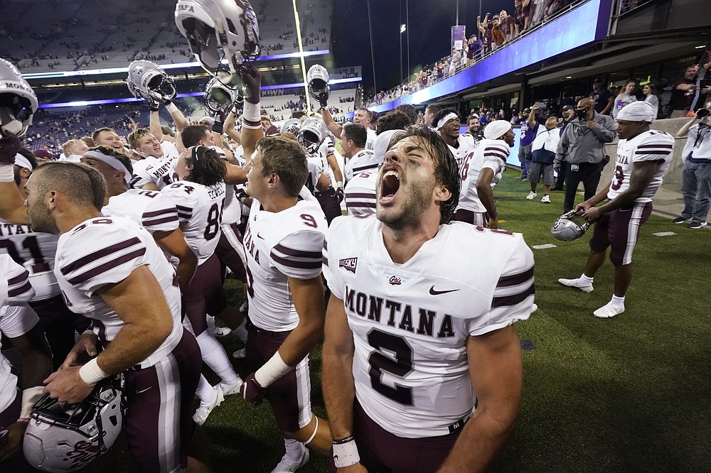 Montana quarterback Cam Humphrey lets out a yell as he celebrates with teammates after they beat Washington in an NCAA college football game Saturday, Sept. 4, 2021, in Seattle. Montana won 13-7. (AP Photo/Elaine Thompson)