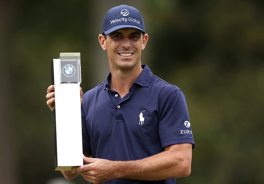 Billy Horschel of the U.S lifts the trophy after victory during day four of the PGA Championship at Wentworth Golf Club, Surrey, England, Sunday, Sept. 12, 2021. (Steven Paston/PA via AP)