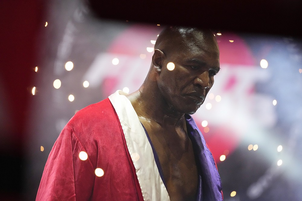 Former heavyweight champ Evander Holyfield walks into the ring for his boxing match against former MMA star Vitor Belfort, Saturday, Sept. 11, 2021, in Hollywood, Fla. (AP Photo/Rebecca Blackwell)