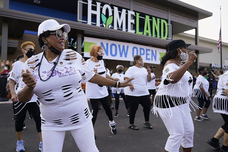 Mentoria Mitchell, of Spencer, Okla., dances with the CommUNITY Line Dancers outside the new Homeland grocery story on Oklahoma City's northeast side, during grand opening ceremonies Wednesday, Sept. 1, 2021, in Oklahoma City. The store is the result of a longtime effort to bring fresh food options to Oklahoma City's historically neglected northeast side.