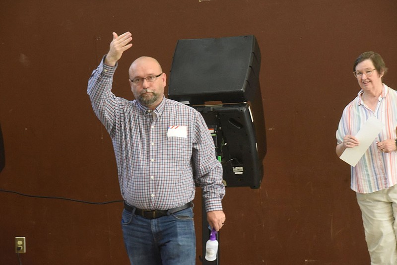 Rodney Fry, poll worker, directs voters to voting machines on Tuesday Sept. 14 2021 during the sales tax election in Pea Ridge. Go to nwaonline.com/210915Daily/ to see more photos.
(NWA Democrat-Gazette/Flip Putthoff)