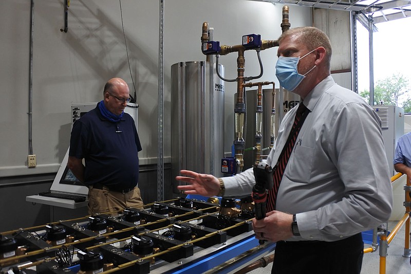 Fort Smith Utility Director Lance McAvoy, right, provides details on a water meter test bench while Kevin Settle, at-large city director, left, listens during a tour of the utility department&#x2019;s maintenance facility at 3900 Kelley Highway during the city Board of Directors study session Tuesday. 
(NWA Democrat-Gazette/Thomas Saccente)