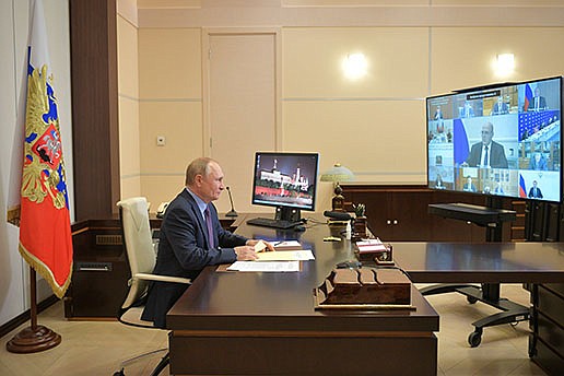 Russian President Vladimir Putin attends a meeting with members of Russian Government and heads of United Russia party via videoconference at the Novo-Ogaryovo residence outside Moscow, Russia, Tuesday, Sept. 14, 2021. Putin entered self-isolation after people in his inner circle became infected with the coronavirus, the Kremlin said Tuesday, adding that the leader himself tested negative for COVID-19. (Alexei Druzhinin, Sputnik, Kremlin Pool Photo via AP)