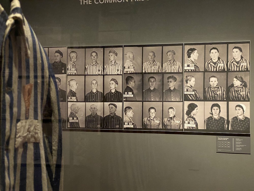 Registration images of prisoners of Auschwitz and a camp striped uniform are part of the touring exhibit now at Union Station in Kansas City, Mo. People incarcerated into the camp were degraded to numbers with no individuality. Their hair was cut, and most had to wear the same kind of clothing, says Pawel Sawicki.
(Pawel Sawicki, Auschwitz Memorial)