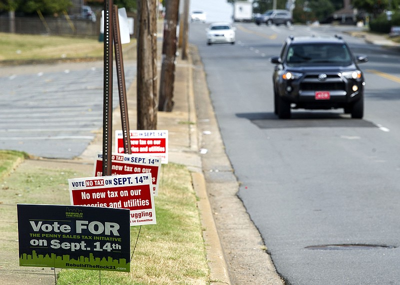 Signs in favor and against the sales-tax referendum stand on display outside a polling location at St. Mark Baptist Church in Little Rock on Tuesday, Sept. 14, 2021.
(Arkansas Democrat-Gazette/Stephen Swofford)