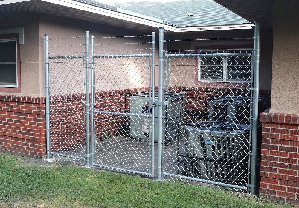 The county fenced off HVAC units at the Garland County Health Unit to keep out the homeless. - Photo by Richard Rasmussen