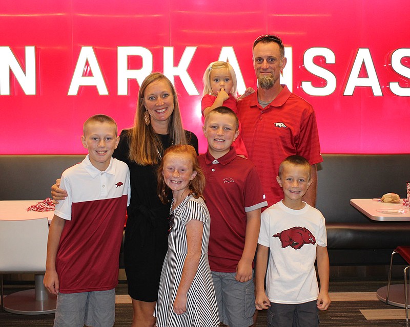 Tiffany Woolley Moyer, member of the 2021 class of theUniversity of Arkansas Hall of Honor (second from left), is joined by her husband Craig and their children Cameron (from left), Miranda, Cale, Katelyn and Owen and a luncheon for honorees Sept. 17 at the Frank Broyles Athletic Center on the UA campus in Fayetteville.
(NWA Democrat-Gazette/Carin Schoppmeyer)