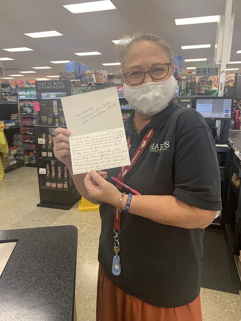 Sally Carroll/Special to The Weekly Vista
Harps staff member Deborah Beichel holds a handwritten thank-you note from volunteers with the Shepherd's Food Pantry who thanked Harps for its commitment to helping the community with the blessing bag program.