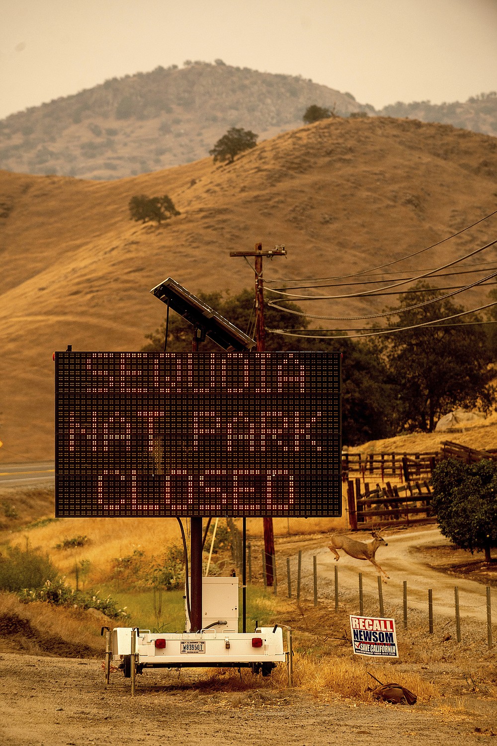 A sign announces the closure of Sequoia National Park, where the KNP Complex Fires are burning, Tuesday, Sept. 14, 2021, in Tulare County, Calif. Individually named the Colony and Paradise Fires, the blazes are burning near the Giant Forest, home to more than 2,000 giant sequoias. (AP Photo/Noah Berger)