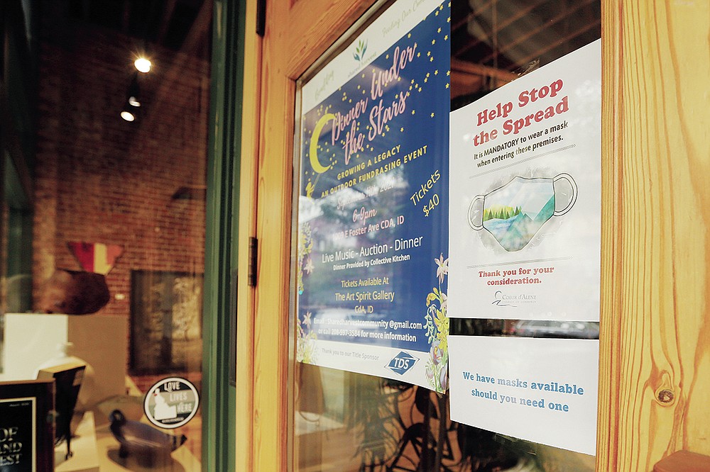 A mandatory mask usage sign is displayed at Art Spirit Gallery, Friday, Sept. 10, 2021, in Coeur d'Alene, Idaho. Northern Idaho has a long and deep streak of antigovernment activism that is confounding attempts to battle a COVID-19 outbreak. (AP Photo/Young Kwak)
