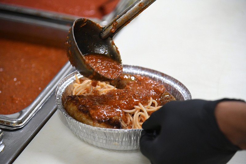 Dominic Clayton, sous chef, makes spaghetti with Italian sausage. - Photo by Tanner Newton of The Sentinel-Record