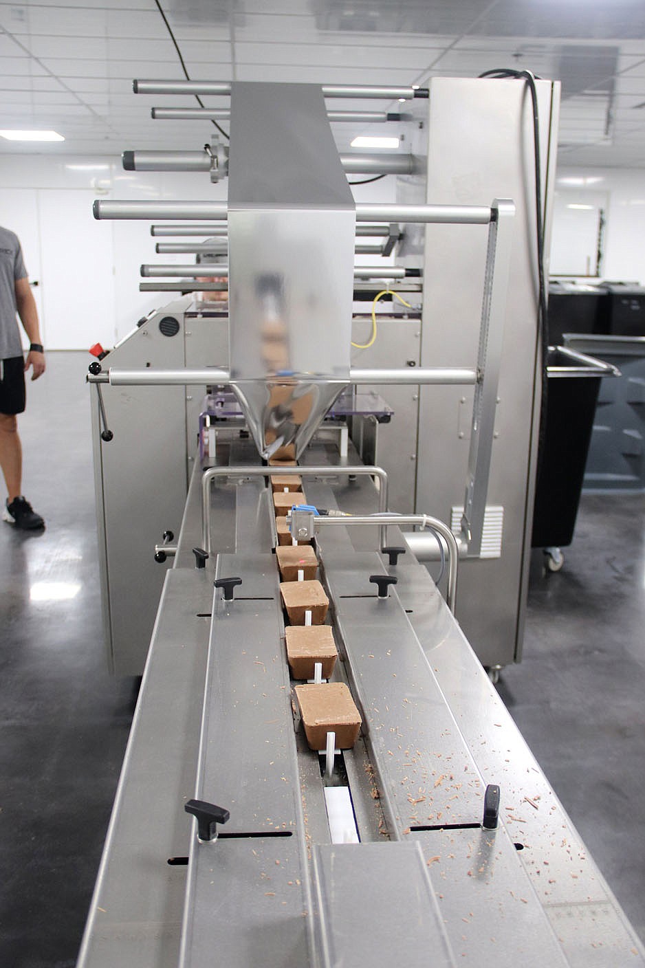 LYNN KUTTER ENTERPRISE-LEADER This conveyer belt takes the Savage Keto Bars into a machine where the bars are covered with a wrapping and then boxed and shipped out across the country.