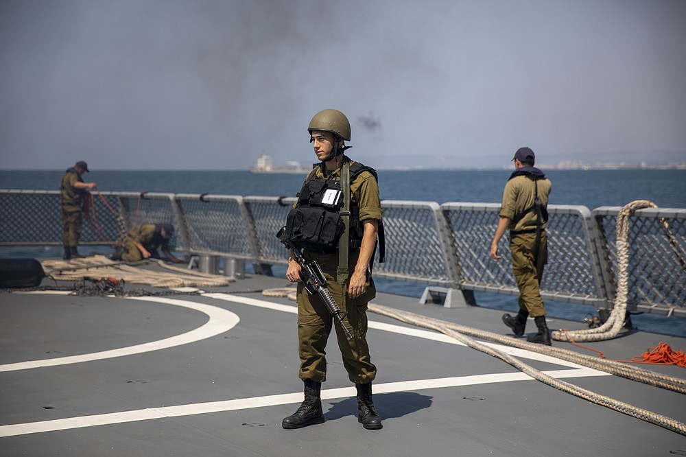 Israeli Navy sailors man the deck of the Israeli Navy Ship Atzmaut, in the Mediterranean Sea , Wednesday, Sept. 1, 2021. In an interview with the Associated Press, Israel's just-retired navy chief Vice Adm. Eli Sharvit, described Iranian activities on the high seas as a top Israeli concern and said the navy is able to strike wherever necessary to protect the country’s economic and security interests. (AP Photo/Ariel Schalit)