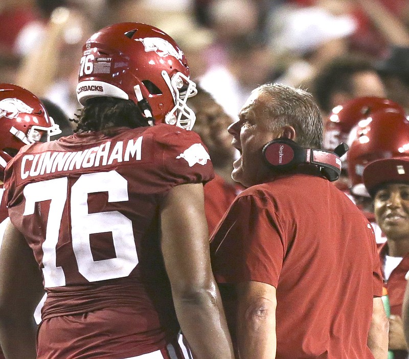 Arkansas head coach Sam Pittman reacts during the third quarter of a Sept. 11 football game at Reynolds Razorback Stadium in Fayetteville while senior offensive tackle Myron Cunningham (76) looks on. - Photo by Charlie Kaijo of NWA Democrat-Gazette