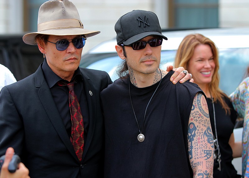 Actor Johnny Depp stands with Damien Echols, right, before speaking at an anti-death-penalty rally on the front steps of Arkansas' Capitol Friday April 14, 2017 in Little Rock, Ark. (Stephen B. Thornton/Arkansas Democrat-Gazette)