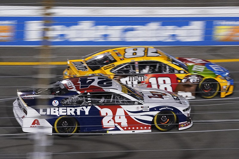 William Byron (24) and Kyle Busch (18) race into turn one during a Sept. 11 NASCAR Cup series race in Richmond, Va. - Photo by Steve Helber of The Associated Press