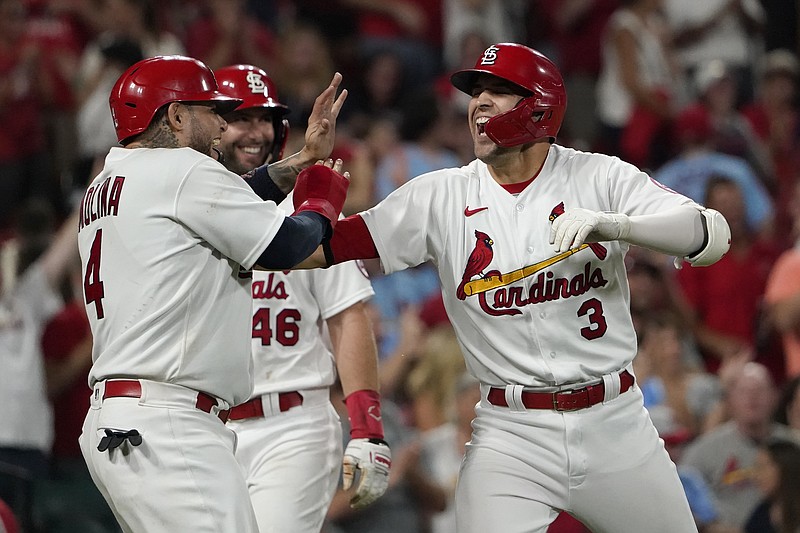 St. Louis Cardinals' Dylan Carlson (3) is congratulated by teammates Yadier Molina (4) and Paul Goldschmidt after hitting a grand slam during the eighth inning of Friday's baseball game against the San Diego Padres in St. Louis. - Photo by Jeff Roberson of The Associated Press