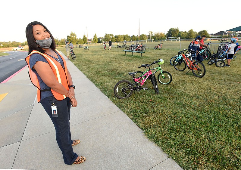 Christina Hamilton, principal at Willow Brook Elementary School in Bentonville, stands by Tuesday Sept. 14 2021 to greet students as they arrive for school on their bikes.
(NWA Democrat-Gazette/Flip Putthoff)