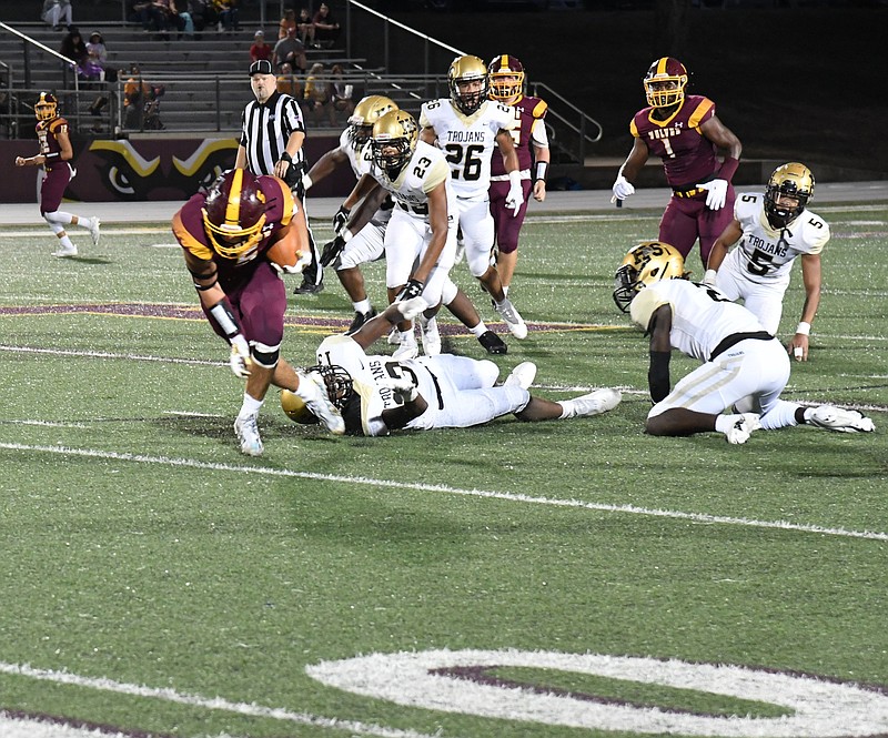 Lake Hamilton's Justin Crutchmer (5) escapes a tackle by Hot Springs' Aamir Andrews (13). The Wolves defeated the Trojans 41-0. - Photo by Tanner Newton of The Sentinel-Record