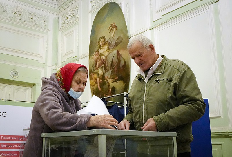 People cast their ballots during the State Duma, the Lower House of the Russian Parliament and local parliaments elections at a polling station situated in an old palace in St. Petersburg, Russia, Saturday, Sept. 18, 2021. Sunday will be the last of three days voting for a new parliament, but there seems to be no expectation that United Russia, the party devoted to President Vladimir Putin, will lose its dominance in the State Duma. (AP Photo/Dmitri Lovetsky)
