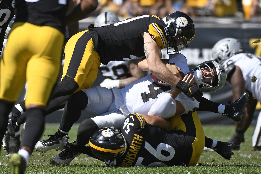 Raiders quarterback Derek Carr (4) makes a sideline pass with Pittsburgh  Steelers cornerback Ja …