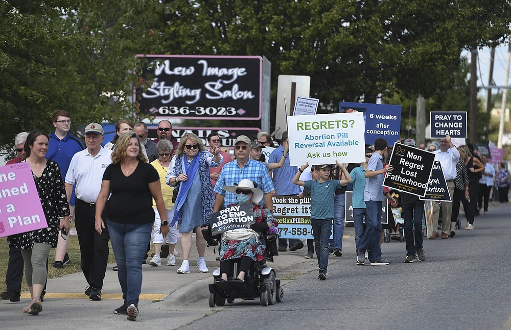 Attendees march, Sunday, September 19, 2021 during an anti-abortion march that started at the parking lot at Locke Supply Co. in Rogers. Lawmakers, state anti-abortion leaders and abortion foes held a march to protest the opening of a Planned Parenthood clinic in Rogers. The clinic is not offering abortions yet, but Planned Parenthood hopes to offer the procedure in the future. Check out nwaonline.com/210920Daily/ for today's photo gallery.
(NWA Democrat-Gazette/Charlie Kaijo)