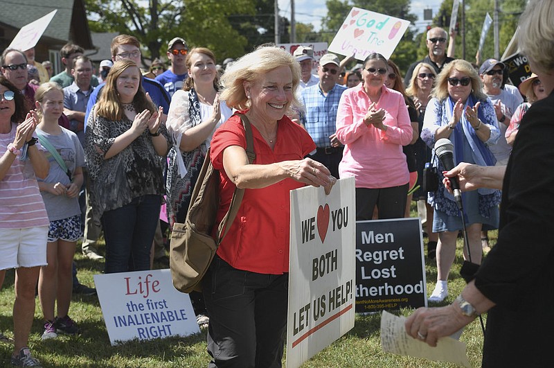 District 91 Rep. Delia Haak prepares to speak, Sunday, September 19, 2021 during an anti-abortion march that started at the parking lot at Locke Supply Co. in Rogers. Lawmakers, state anti-abortion leaders and abortion foes held a march to protest the opening of a Planned Parenthood clinic in Rogers. The clinic is not offering abortions yet, but Planned Parenthood hopes to offer the procedure in the future. Check out nwaonline.com/210920Daily/ for today's photo gallery. 
(NWA Democrat-Gazette/Charlie Kaijo)