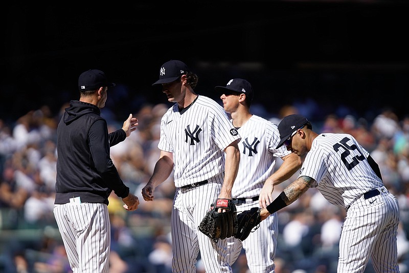 New York Yankees starting pitcher Gerrit Cole, center, is relieved in the sixth inning of a baseball game against the Cleveland Indians, Sunday, Sept. 19, 2021, in New York. (AP Photo/Eduardo Munoz Alvarez)