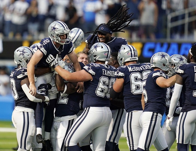 Dallas Cowboys kicker Greg Zuerlein (2) is lifted by teammates after making the game-winning field goal as time expired during the second half of an NFL football game against the Los Angeles Chargers Sunday, Sept. 19, 2021, in Inglewood, Calif. (AP Photo/Gregory Bull)