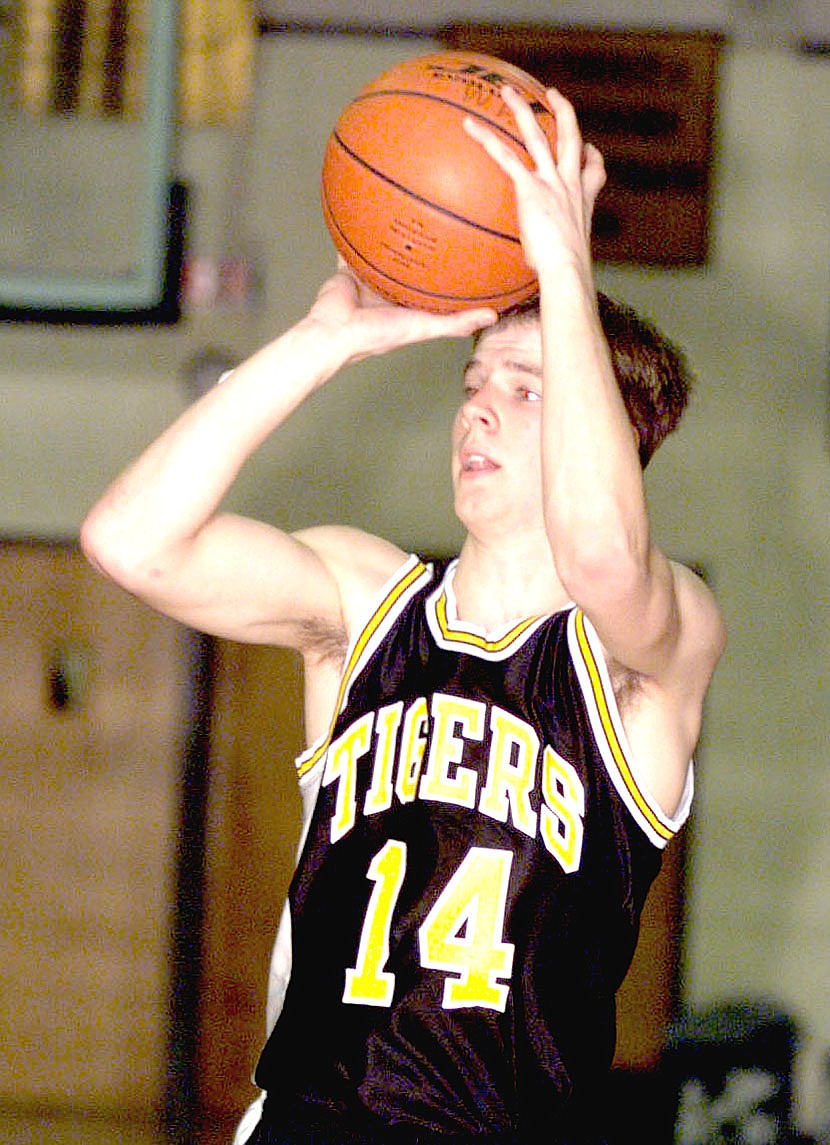 Arkansas Democrat Gazette/BOB COLEMAN/In this historical game photo, Prairie Grove's Dustin Dougan, then a senior in high school, looks to make a pass during a game against West Fork on Tuesday, Jan. 19, 1999. The former Tiger basketball star, whom teammate Patrick Abshier remembers could make shots from anywhere across halfcourt, married his high school sweetheart, Shelley Ledford, now Shelley Dougan. The couple have been married 17 years and raised their two children in the community. Dustin was diagnosed with Maxillary sinus cancer in 2019. In March doctors removed Dustin's left eye because of the cancer and there were complications. He suffered a stroke and continues to fight to regain his health.