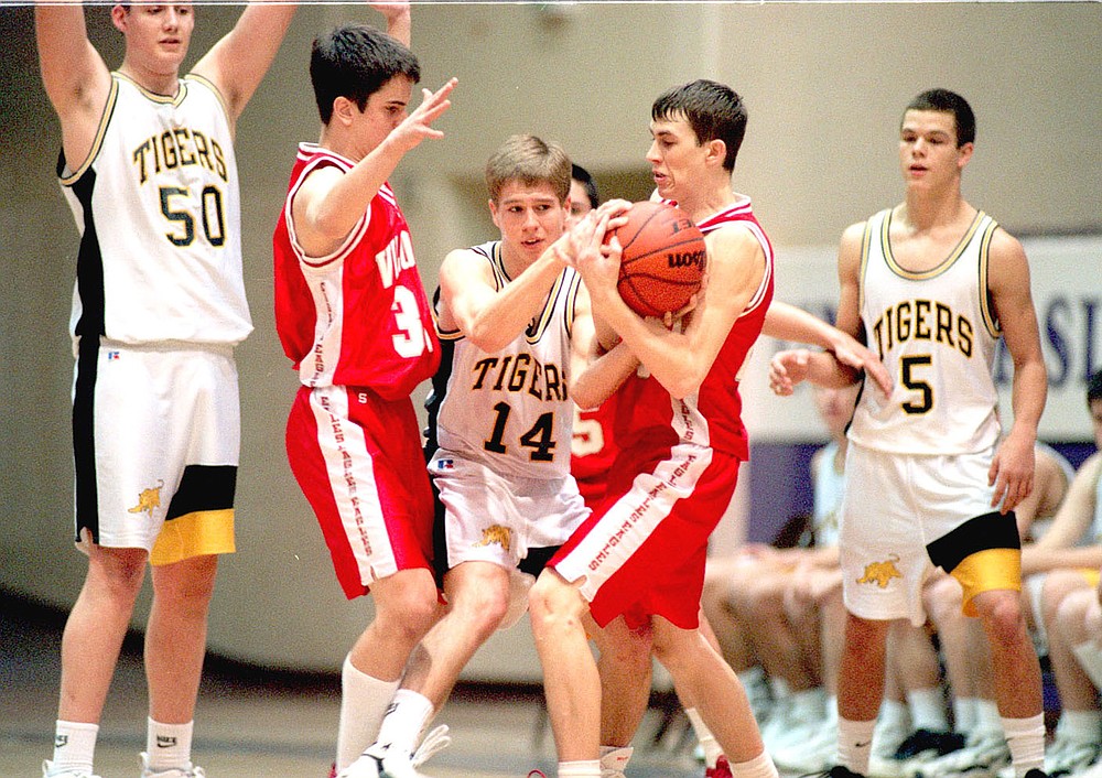 Arkansas Democrat-Gazette/KAREN VANDONGE/Prairie Grove's Dustin Dougan (No. 14) fights for the ball with Vilonia's Nick Weaver (left) and Clint Mears during the second half of their game on the afternoon of Wednesday, Dec. 12, 1998, during the UCA high school tournament. Prairie Grove won and advanced to the semifinals. Dougan's high school teammates, Luke Morris (No. 50), a 6-9 center, and Patrick Abshier (No. 5) are also pictured. The trio of big scorers caused match-up problems for Tiger opponents during their careers.