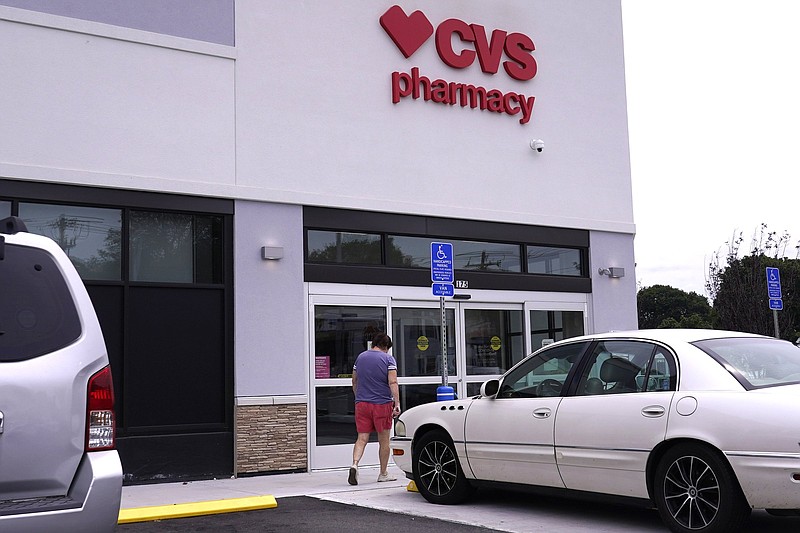 A customer walks into a CVS Pharmacy store, Tuesday, Aug. 3, 2021, in Woburn, Mass. Customers returned to CVS Health stores to fill prescriptions and get COVID-19 tests and vaccines, helping to push the health care giant past Wall Street?s second-quarter expectations. (AP Photo/Charles Krupa)