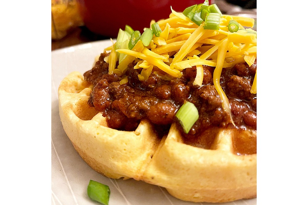 Weeknight Chili tops a cornbread waffle with shredded cheese and green onion. (Arkansas Democrat-Gazette/Kelly Brant)