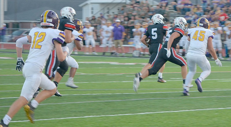 Al Gaspeny/Special to McDonald County Press
McDonald County's Colton Ruddick (5) looks for running room as Destyn Dowd blocks against Monett last Friday at Mustang Stadium.