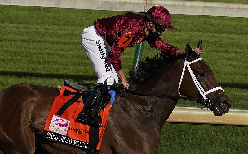 Jockey Florent Geroux pats Shedaresthedevil on the head after winning the 146th running of the Kentucky Oaks on Sept. 4, 2020, at Churchill Downs in Louisville, Ky. The 4-year-old filly posted her fourth graded victory of 2021 Saturday night in the $400,000 Locust Grove at Churchill Downs. - Photo by Charlie Riedel of The Associated Press
