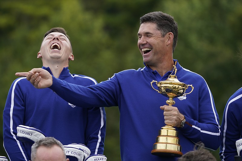 Team Europe captain Padraig Harrington and Team Europe's Matt Fitzpatrick smile as they pose for a team picture during a practice day at the Ryder Cup at the Whistling Straits Golf Course on Tuesday in Sheboygan, Wis. - Photo by Charlie Neibergall of The Associated Press