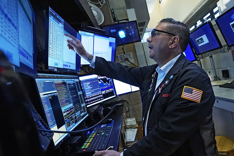 Trader Jonathan Mueller works in his booth on the floor of the New York Stock Exchange, Tuesday, Sept. 21, 2021. Stocks are opening modestly higher on Wall Street, making up some of the ground they lost in a sharp pullback a day earlier. (AP Photo/Richard Drew)