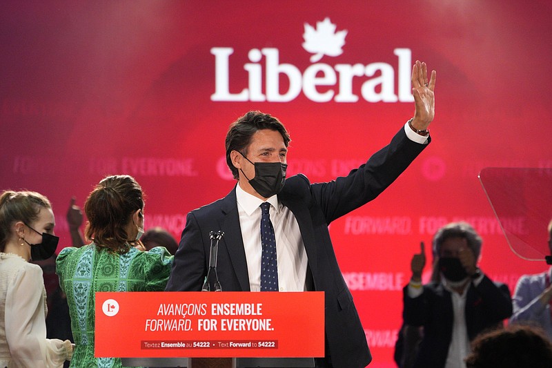 Liberal Leader Justin Trudeau greets supporters prior to his victory speech at Party campaign headquarters in Montreal, early Tuesday, Sept. 21, 2021.  (Paul Chiasson/The Canadian Press via AP)
